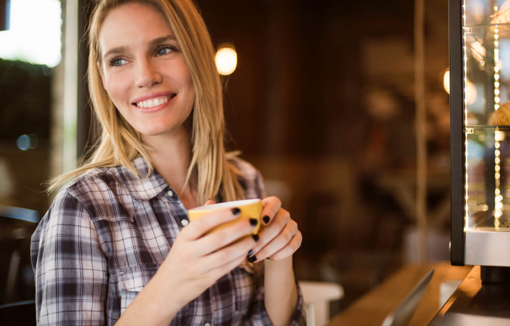 Woman with a nice smile holding a coffee mug