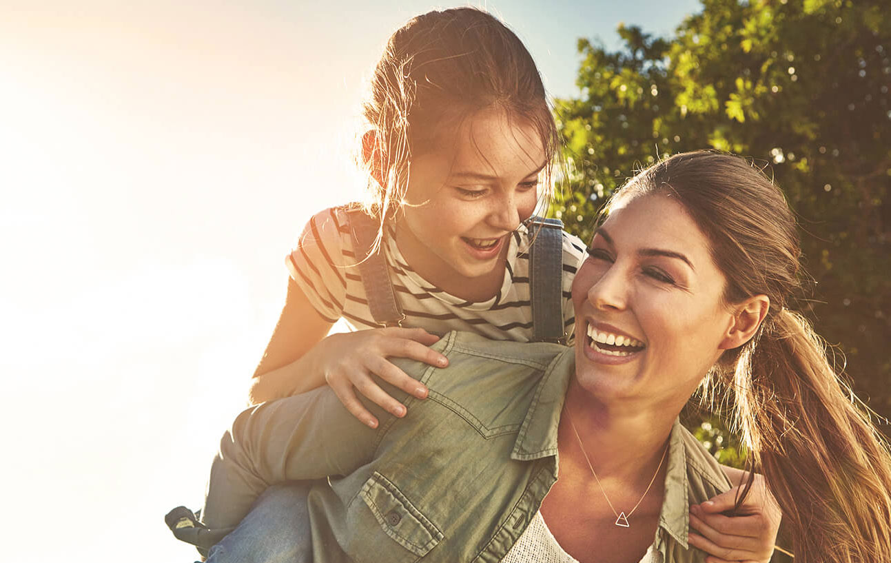 Woman and her child playing outdoors